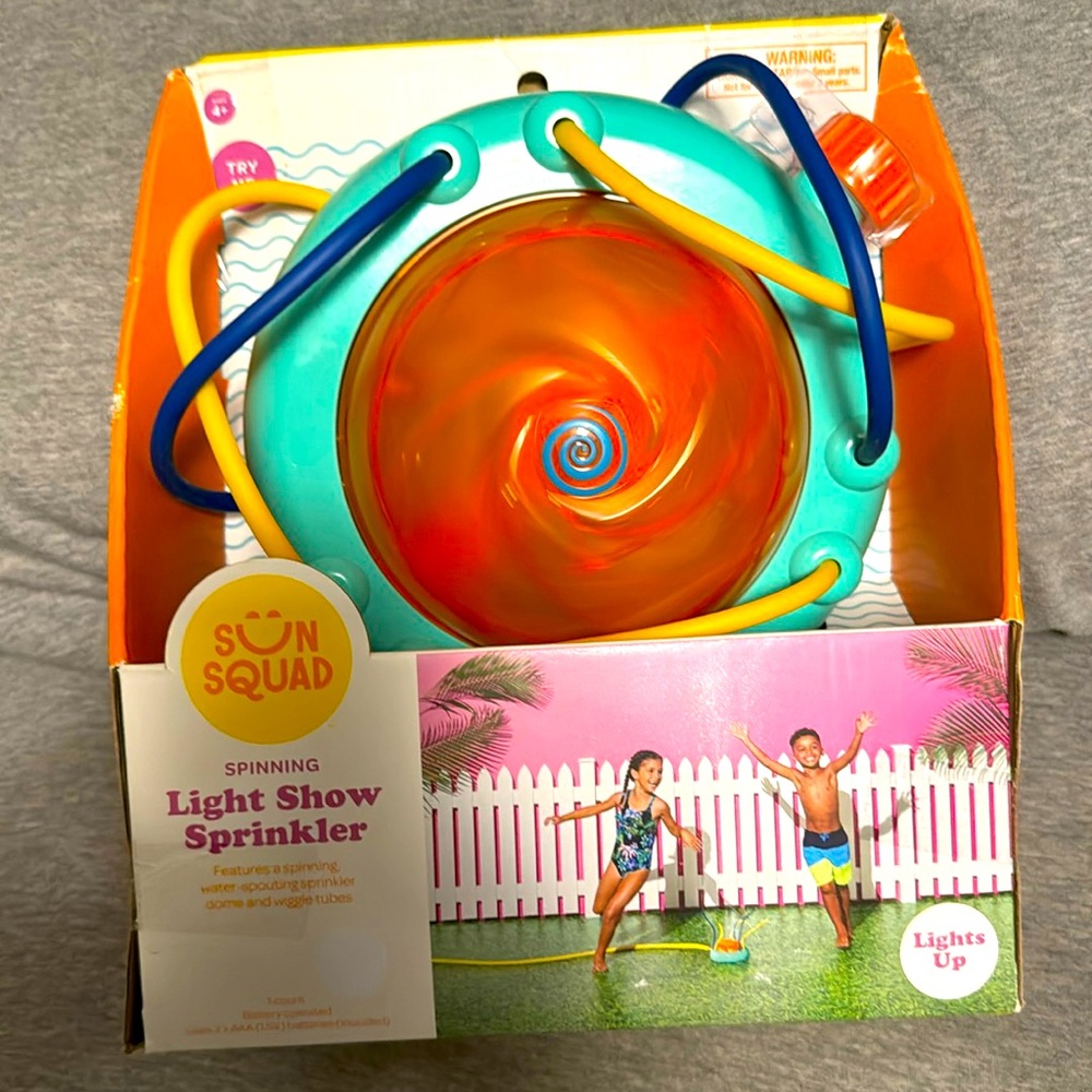 Sun Squad spinning, light up sprinkler. Orange with water spouting wiggle tubes.